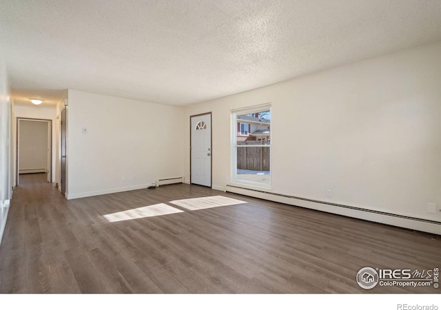 1620-1626 E 17th St, Loveland, CO 80538 - unfurnished room featuring wood finished floors, a textured ceiling, a baseboard heating unit, and a baseboard radiator