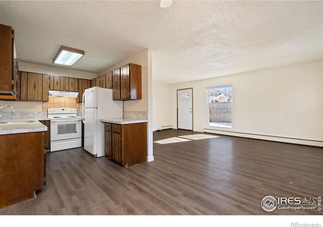 1620-1626 E 17th St, Loveland, CO 80538 - kitchen with white appliances, under cabinet range hood, a baseboard heating unit, dark wood-type flooring, and a textured ceiling