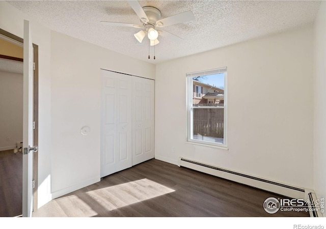1620-1626 E 17th St, Loveland, CO 80538 - unfurnished bedroom featuring baseboard heating, wood finished floors, a textured ceiling, a closet, and ceiling fan