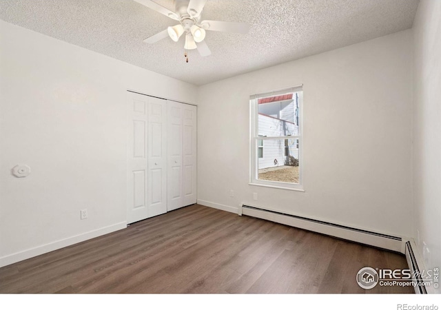 1620-1626 E 17th St, Loveland, CO 80538 - unfurnished bedroom with a baseboard heating unit, wood finished floors, a textured ceiling, a closet, and ceiling fan