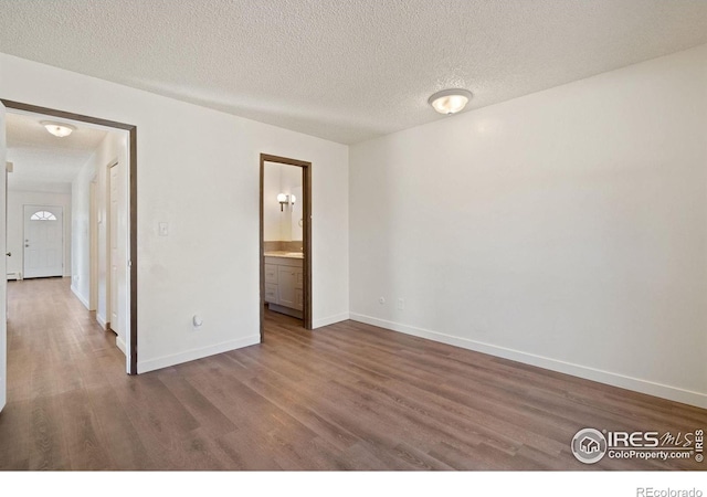 1620-1626 E 17th St, Loveland, CO 80538 - empty room featuring wood finished floors and a textured ceiling