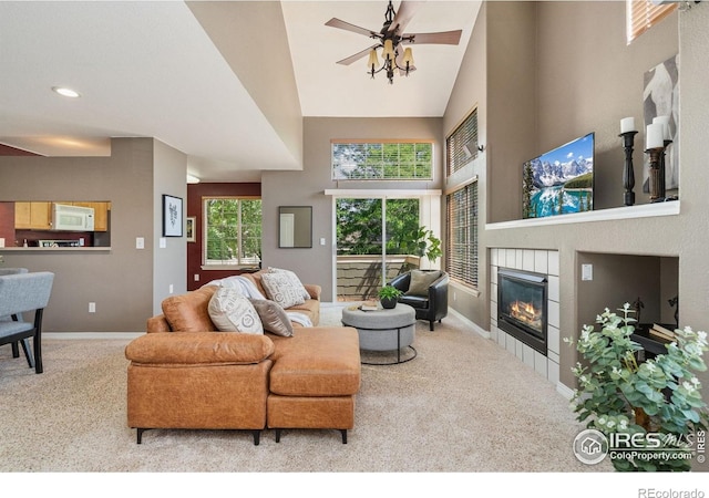6721 Antigua Dr Unit 57, Fort Collins, CO 80525 - carpeted living area with a tiled fireplace, a high ceiling, ceiling fan, and recessed lighting