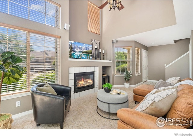 6721 Antigua Dr Unit 57, Fort Collins, CO 80525 - carpeted living area with a tile fireplace, a high ceiling, and stairs