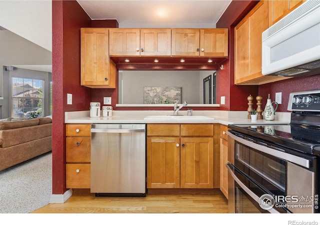 6721 Antigua Dr Unit 57, Fort Collins, CO 80525 - kitchen with stainless steel appliances, light countertops, and light wood finished floors