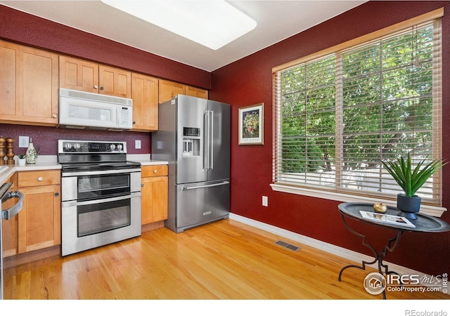 6721 Antigua Dr Unit 57, Fort Collins, CO 80525 - kitchen with stainless steel appliances, light wood-type flooring, light countertops, and healthy amount of natural light
