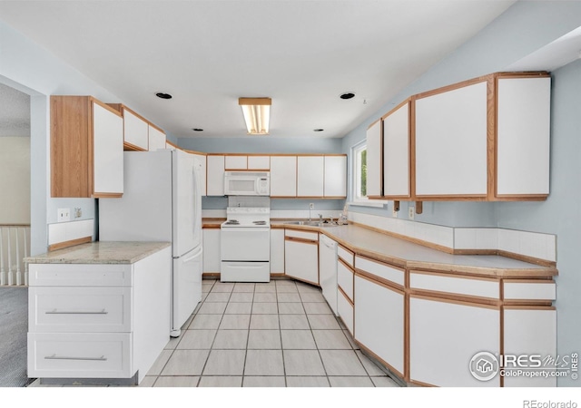11450 Hudson St, Thornton, CO 80233 - kitchen with white appliances, light countertops, and white cabinets