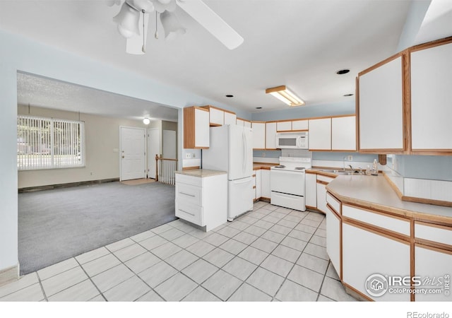 11450 Hudson St, Thornton, CO 80233 - kitchen featuring white appliances, light colored carpet, light countertops, a ceiling fan, and light tile patterned floors