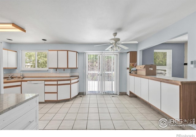 11450 Hudson St, Thornton, CO 80233 - kitchen featuring white dishwasher, white cabinets, healthy amount of natural light, and ceiling fan