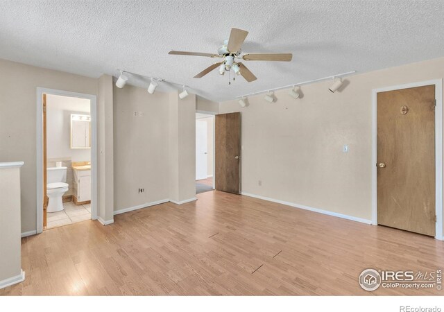 11450 Hudson St, Thornton, CO 80233 - unfurnished room with track lighting, ceiling fan, light wood-style flooring, and a textured ceiling