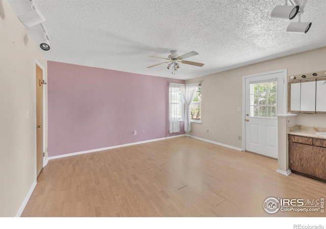 11450 Hudson St, Thornton, CO 80233 - empty room featuring light wood-style floors, ceiling fan, and a textured ceiling
