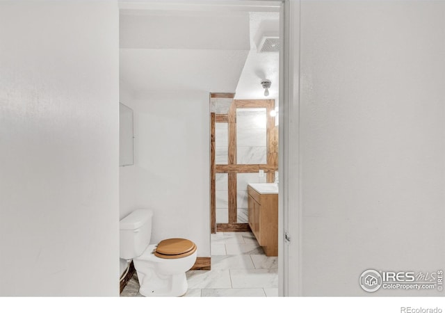 11450 Hudson St, Thornton, CO 80233 - bathroom featuring vanity and marble finish flooring