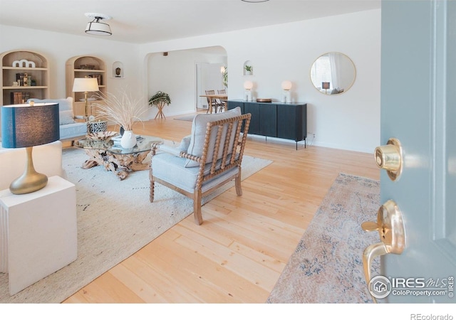 1539 Peterson St, Fort Collins, CO 80524 - living room featuring arched walkways, wood finished floors, and built in shelves
