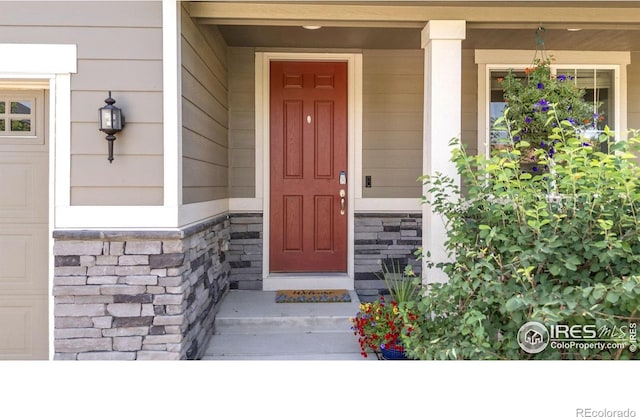6244 Waterman Way, Frederick, CO 80516 - property entrance featuring a porch and stone siding