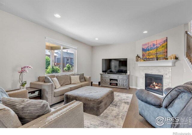 6244 Waterman Way, Frederick, CO 80516 - living room with wood finished floors, a glass covered fireplace, and recessed lighting