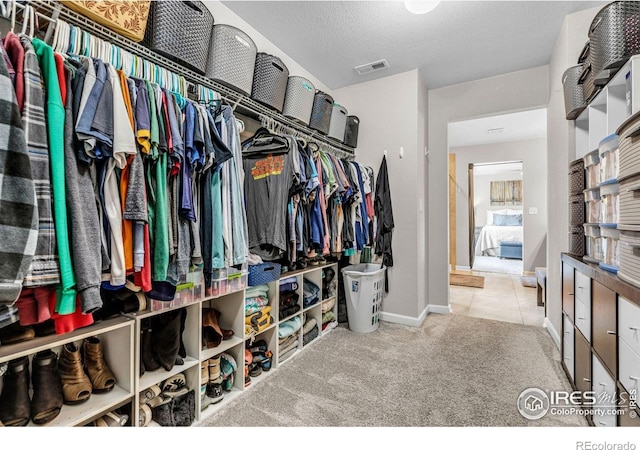 6244 Waterman Way, Frederick, CO 80516 - walk in closet featuring carpet floors and tile patterned floors