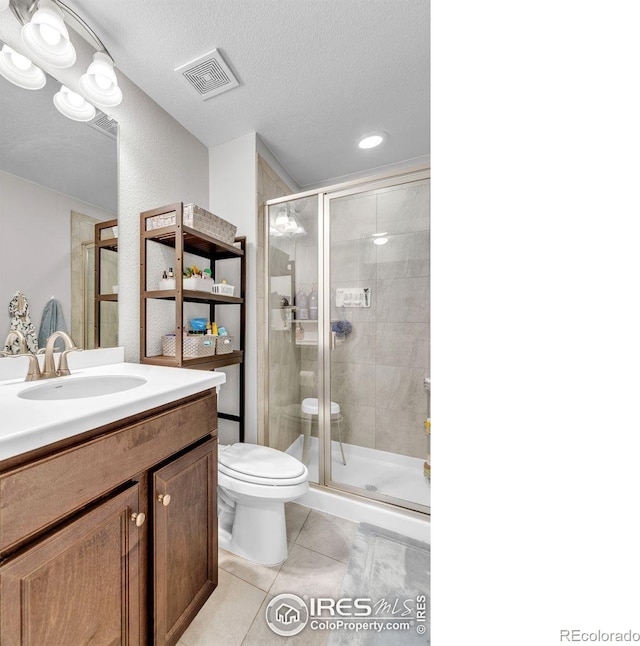 6244 Waterman Way, Frederick, CO 80516 - full bathroom with a stall shower, tile patterned flooring, vanity, recessed lighting, and a textured ceiling