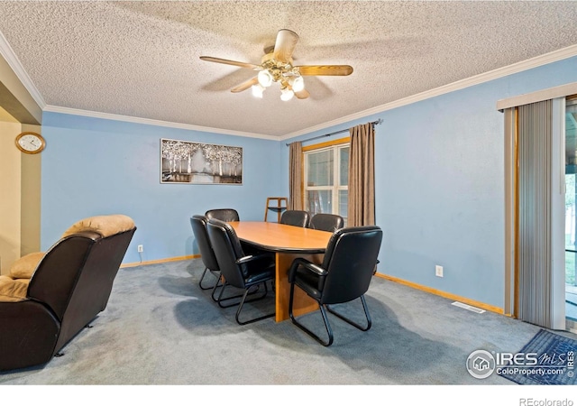 611 Elizabeth Ave, Platteville, CO 80651 - dining space with crown molding, a ceiling fan, carpet flooring, healthy amount of natural light, and a textured ceiling