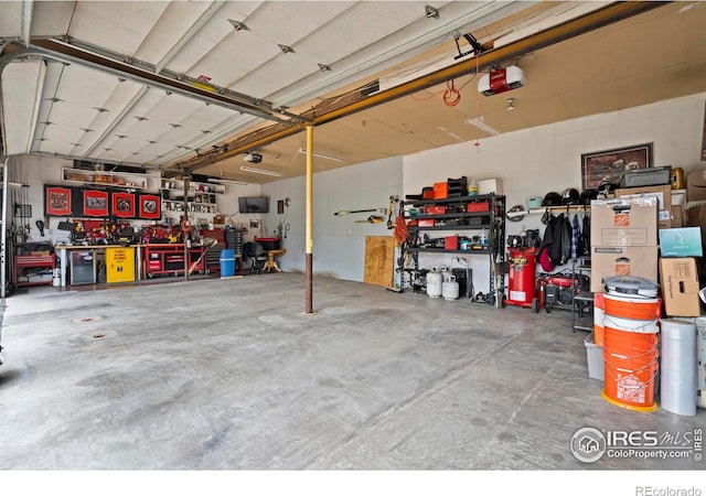 611 Elizabeth Ave, Platteville, CO 80651 - garage with a workshop area and a garage door opener
