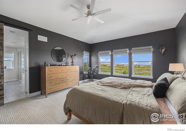 19239 W 88th Dr, Arvada, CO 80007 - bedroom featuring light carpet, multiple windows, a ceiling fan, vaulted ceiling, and ensuite bath