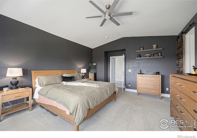 19239 W 88th Dr, Arvada, CO 80007 - bedroom with vaulted ceiling, a barn door, light carpet, and ceiling fan