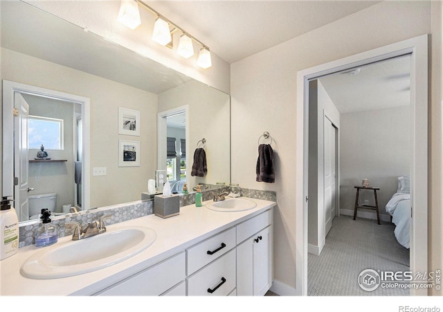 19239 W 88th Dr, Arvada, CO 80007 - full bath with double vanity, connected bathroom, and plenty of natural light