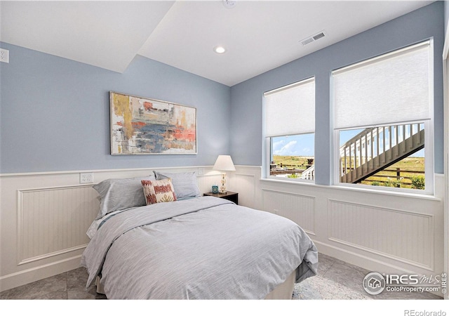 19239 W 88th Dr, Arvada, CO 80007 - tiled bedroom featuring wainscoting, a decorative wall, and recessed lighting