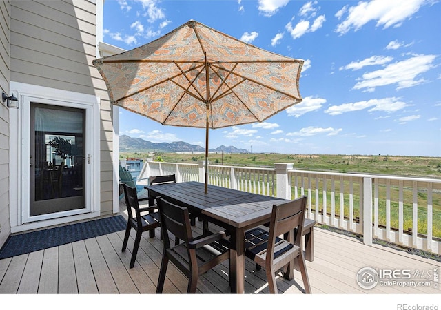 19239 W 88th Dr, Arvada, CO 80007 - wooden deck with outdoor dining space and a mountain view
