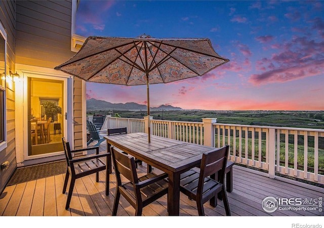 19239 W 88th Dr, Arvada, CO 80007 - deck at dusk with outdoor dining space and a mountain view