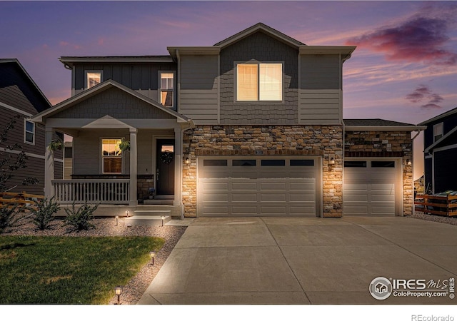 7415 E 158th Pl, Thornton, CO 80602 - craftsman inspired home featuring stone siding, concrete driveway, covered porch, and a garage