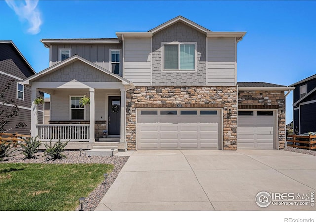 7415 E 158th Pl, Thornton, CO 80602 - craftsman-style home with stone siding, driveway, a porch, and an attached garage