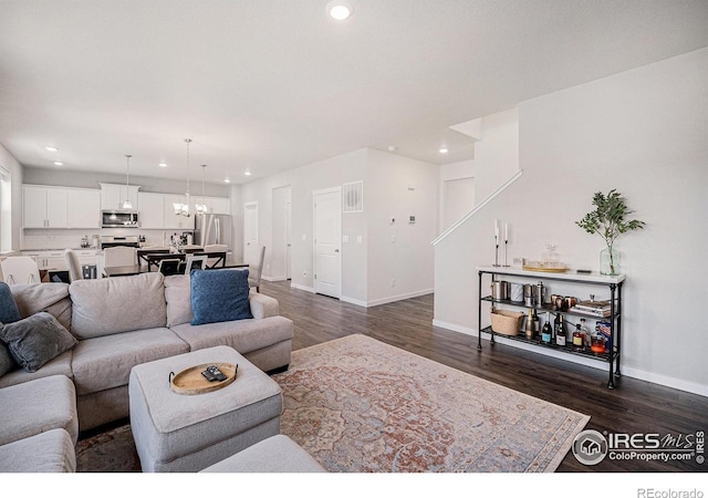 7415 E 158th Pl, Thornton, CO 80602 - living room featuring recessed lighting, dark wood-style floors, and a chandelier