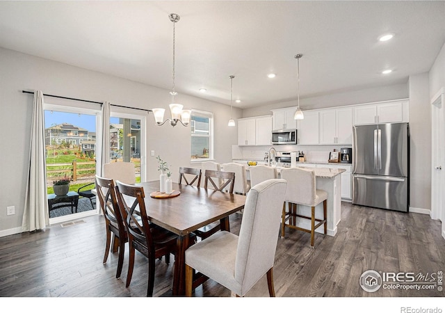 7415 E 158th Pl, Thornton, CO 80602 - dining room featuring recessed lighting, dark wood-type flooring, and a chandelier