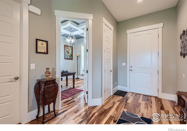 5279 Long Dr, Timnath, CO 80547 - foyer entrance featuring light wood finished floors, a chandelier, and recessed lighting