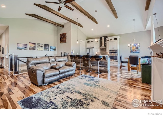 5279 Long Dr, Timnath, CO 80547 - living area with beamed ceiling, light wood-style floors, a ceiling fan, high vaulted ceiling, and a chandelier