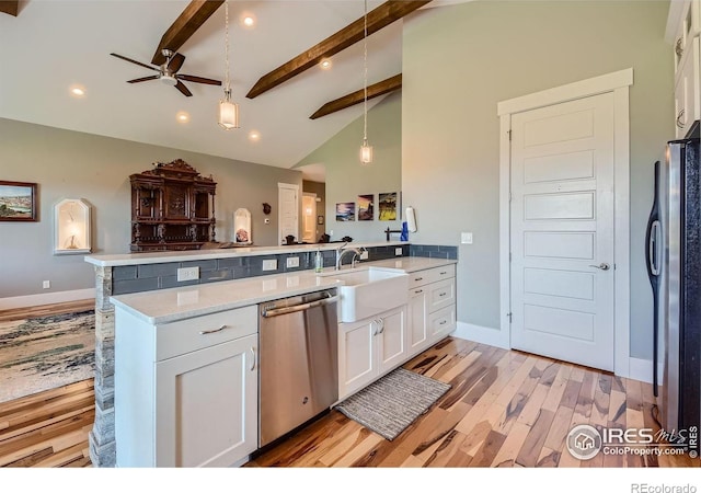 5279 Long Dr, Timnath, CO 80547 - kitchen featuring appliances with stainless steel finishes, a ceiling fan, a peninsula, light wood-style flooring, and white cabinetry