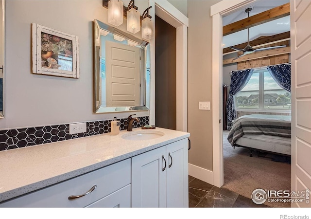 5279 Long Dr, Timnath, CO 80547 - bathroom with vanity, ceiling fan, marble look tile flooring, connected bathroom, and tasteful backsplash