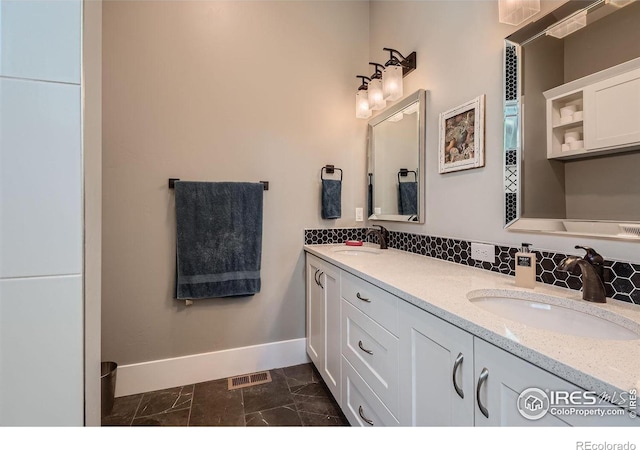5279 Long Dr, Timnath, CO 80547 - bathroom featuring double vanity, marble finish floors, and tasteful backsplash