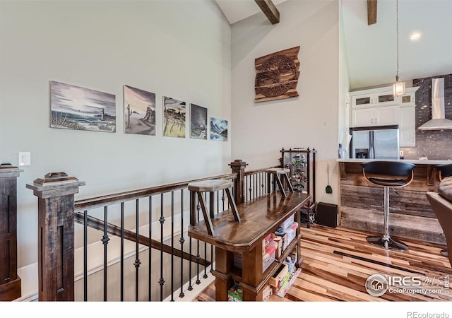 5279 Long Dr, Timnath, CO 80547 - corridor with wood finished floors, an upstairs landing, and high vaulted ceiling