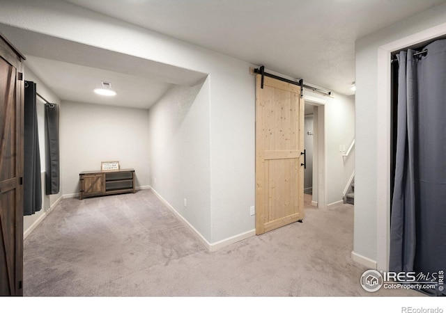 6836 Timpas Dr, Fort Collins, CO 80525 - corridor with a barn door, carpet flooring, and stairway