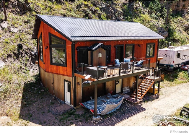 200 Falls Creek Dr, Bellvue, CO 80512 - view of front of home featuring a standing seam roof, stairs, a metal roof, and a deck