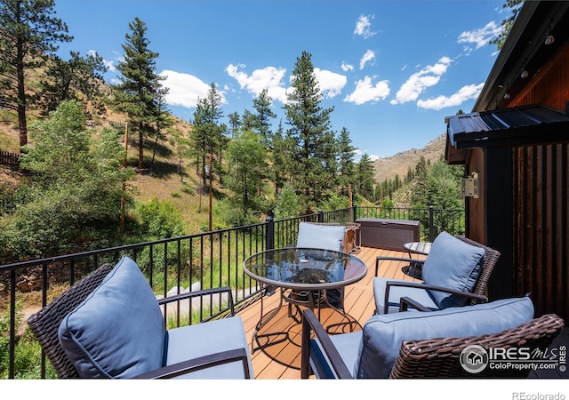 200 Falls Creek Dr, Bellvue, CO 80512 - wooden deck featuring outdoor dining space and a mountain view