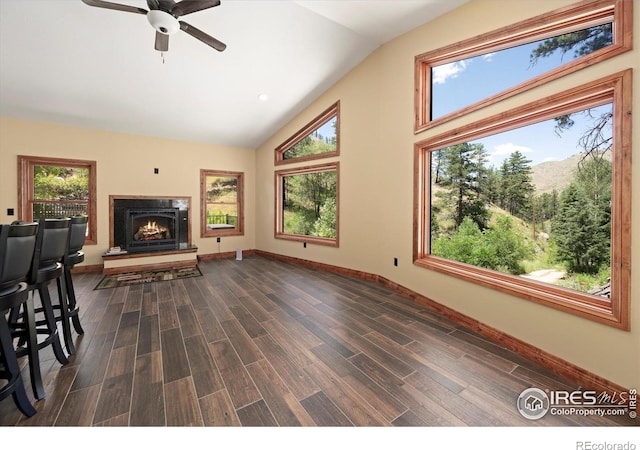 200 Falls Creek Dr, Bellvue, CO 80512 - unfurnished living room with ceiling fan, wood finished floors, a lit fireplace, and high vaulted ceiling