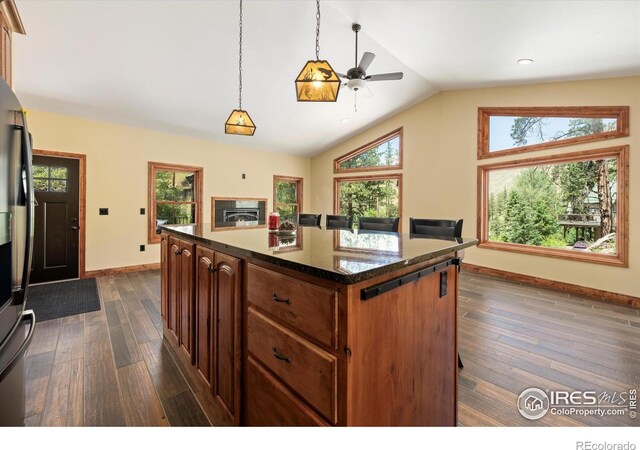200 Falls Creek Dr, Bellvue, CO 80512 - kitchen featuring a ceiling fan, lofted ceiling, dark wood finished floors, refrigerator with ice dispenser, and decorative light fixtures