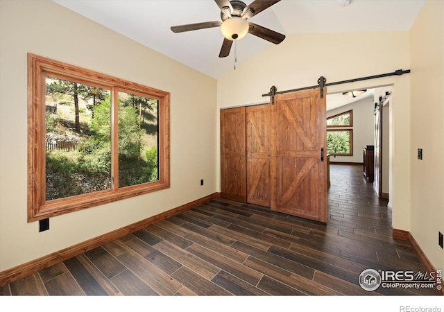 200 Falls Creek Dr, Bellvue, CO 80512 - spare room featuring lofted ceiling, dark wood-style flooring, ceiling fan, a barn door, and a smoke detector