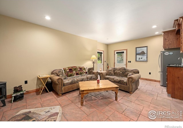 200 Falls Creek Dr, Bellvue, CO 80512 - living area featuring stone tile floors, a wood stove, and recessed lighting