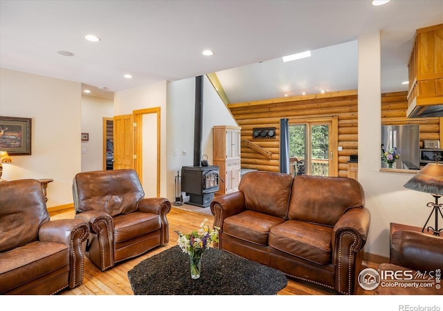 280 Hummer Dr, Nederland, CO 80466 - living area with a wood stove, light wood-type flooring, rustic walls, and recessed lighting