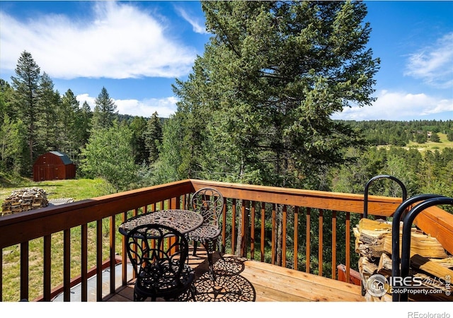280 Hummer Dr, Nederland, CO 80466 - wooden terrace featuring a storage shed and a forest view