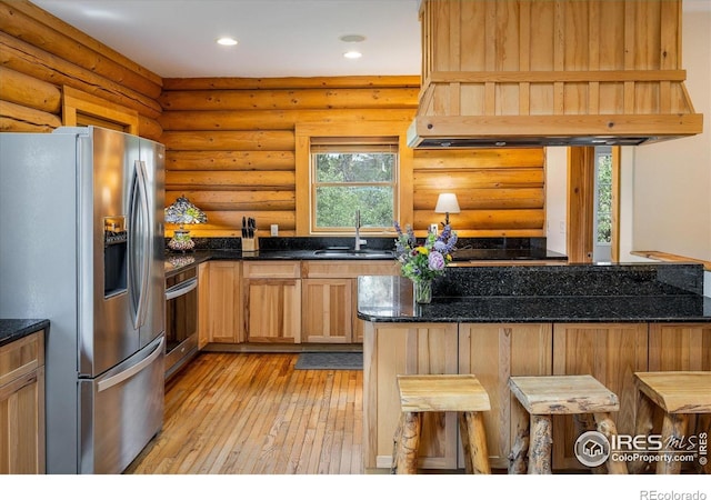 280 Hummer Dr, Nederland, CO 80466 - kitchen with stainless steel fridge with ice dispenser, recessed lighting, custom range hood, light wood-type flooring, and dark stone countertops