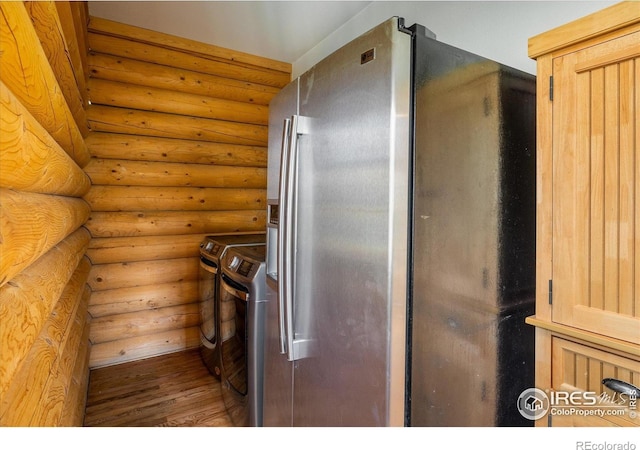 280 Hummer Dr, Nederland, CO 80466 - laundry room with washing machine and dryer, log walls, and wood finished floors