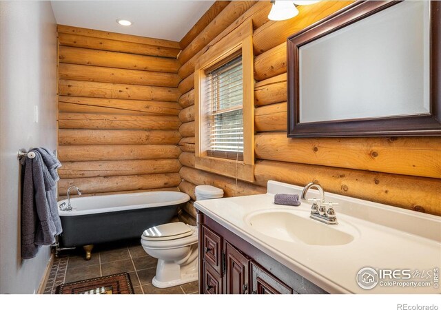 280 Hummer Dr, Nederland, CO 80466 - bathroom featuring a freestanding bath, vanity, rustic walls, tile patterned floors, and recessed lighting